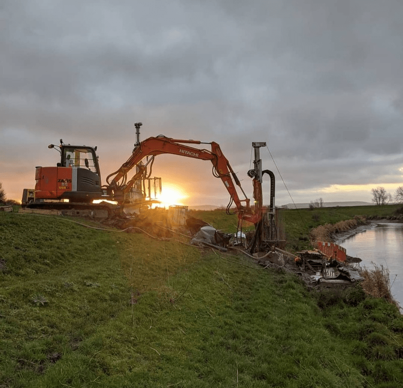 excavator and two drillers facing camera